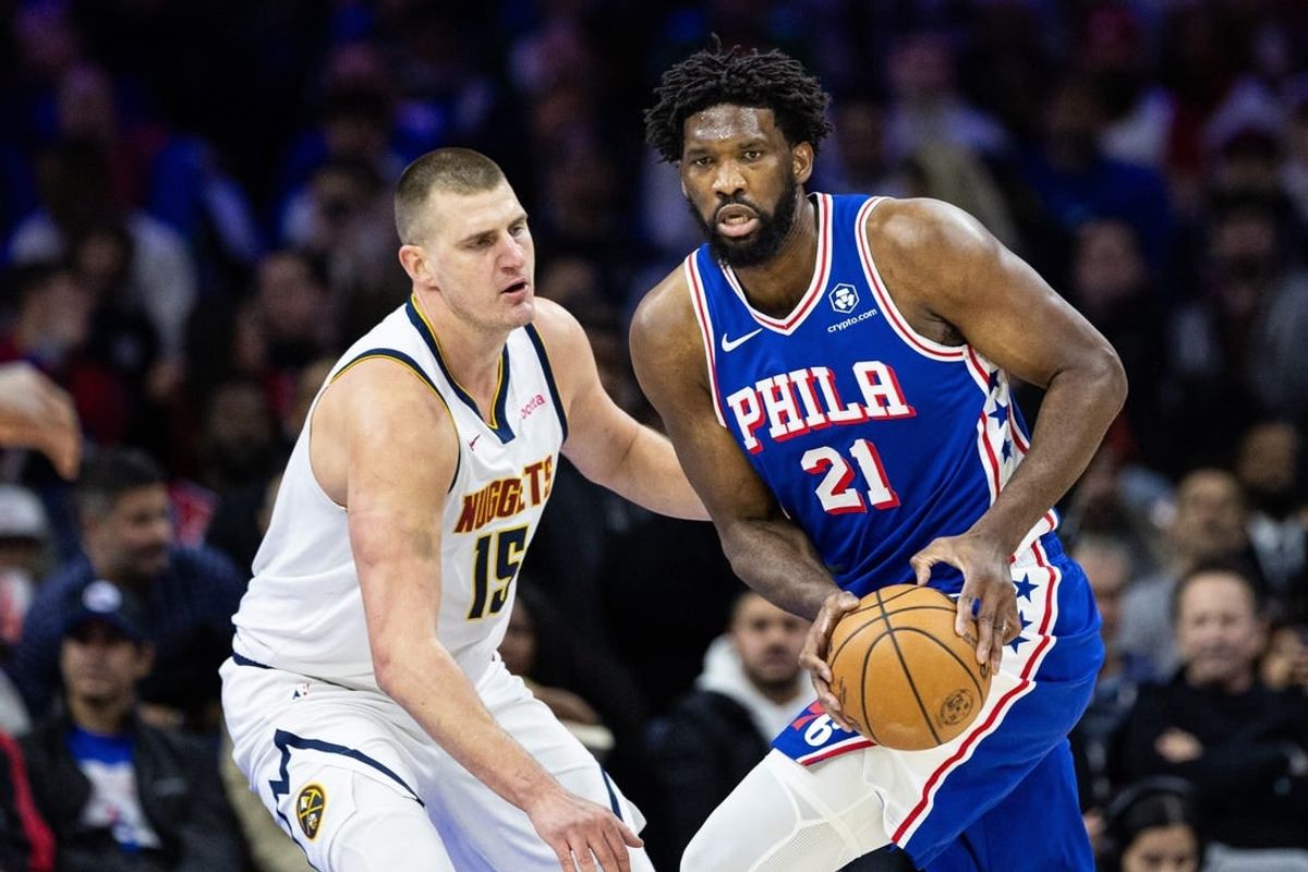 Jan 16, 2024; Philadelphia, Pennsylvania, USA; Philadelphia 76ers center Joel Embiid (21) controls the ball against Denver Nuggets center Nikola Jokic (15) during the first quarter at Wells Fargo Center.