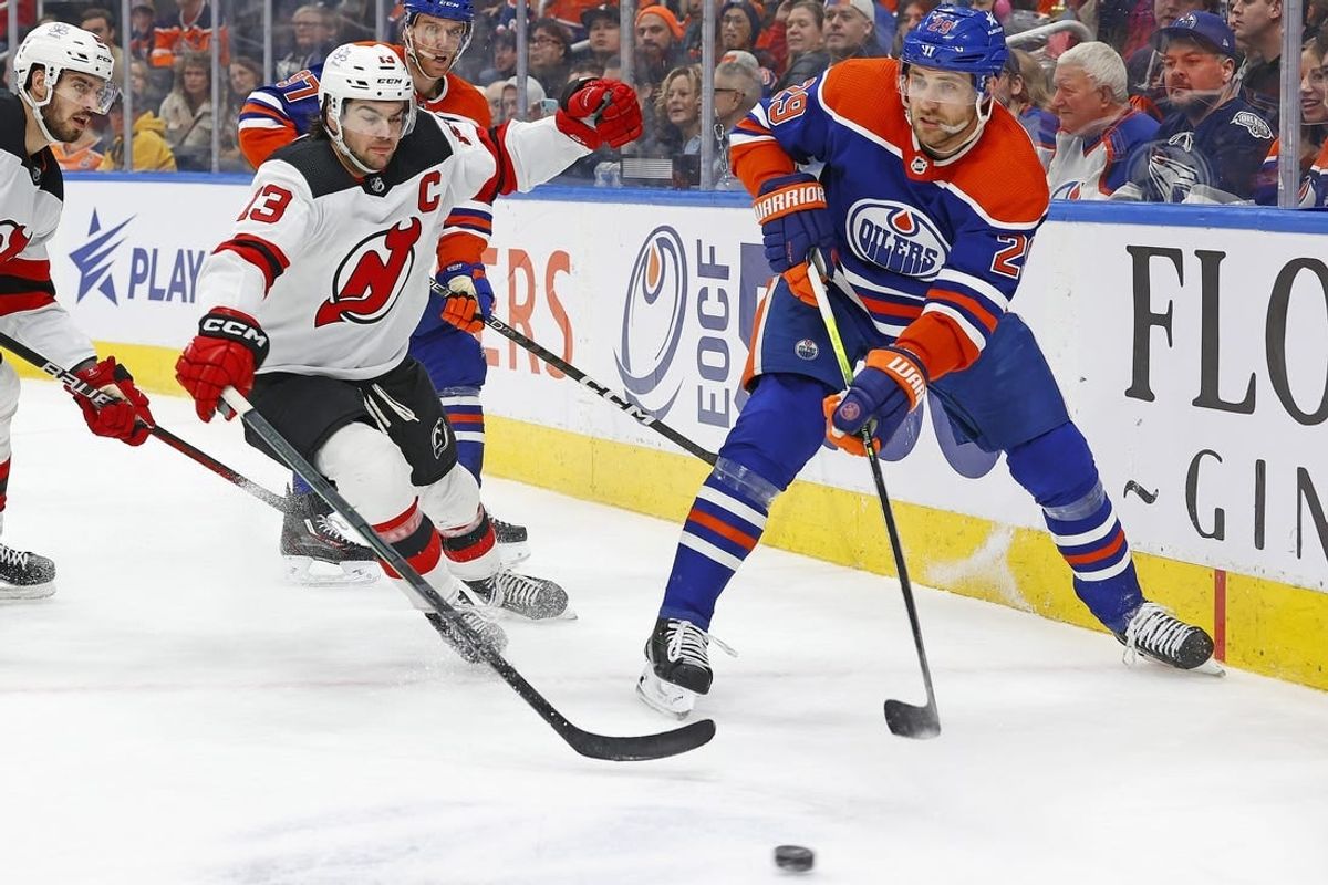 Dec 10, 2023; Edmonton, Alberta, CAN; Edmonton Oilers forward Leon Draisaitl (29) makes pass in front of to f New Jersey Devils forward Nico Hischier (13) during the first period at Rogers Place.