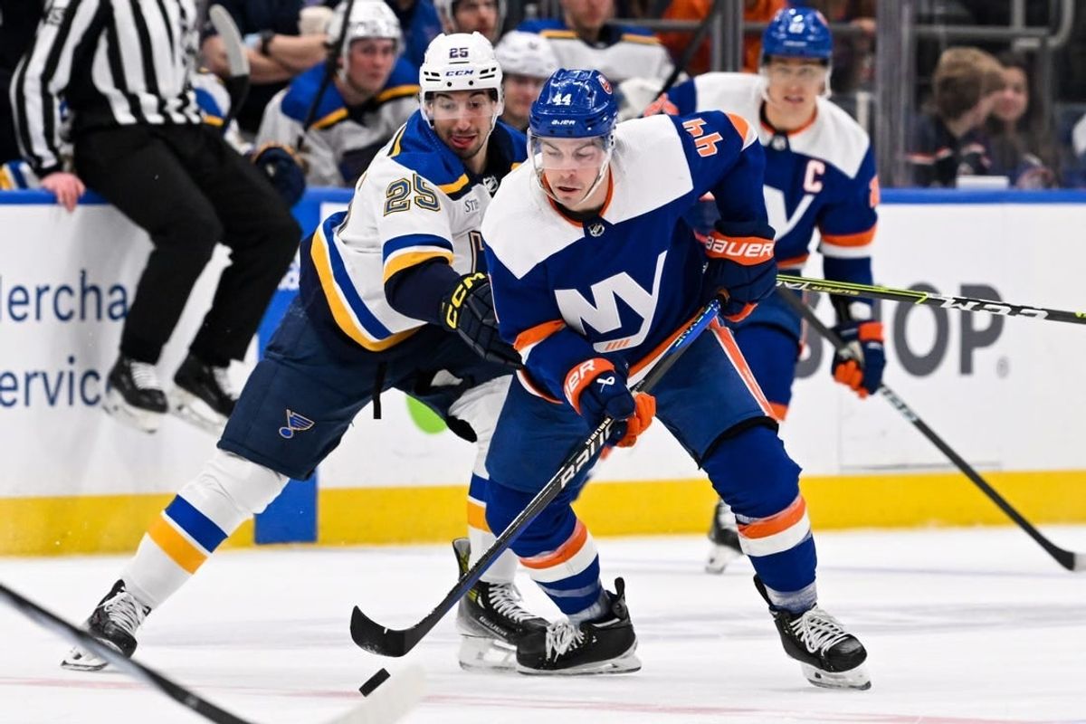 Mar 5, 2024; Elmont, New York, USA;  New York Islanders center Jean-Gabriel Pageau (44) and St. Louis Blues center Jordan Kyrou (25) battle for a loose puck during the first period at UBS Arena.
