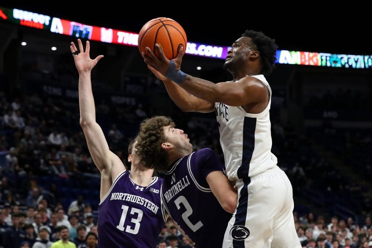 Jan 10, 2024; University Park, Pennsylvania, USA; Penn State Nittany Lions guard Kanye Clary (0) drives the ball to the basket while being fouled by Northwestern Wildcats forward Nick Martinelli (2) during the first half at Bryce Jordan Center.
