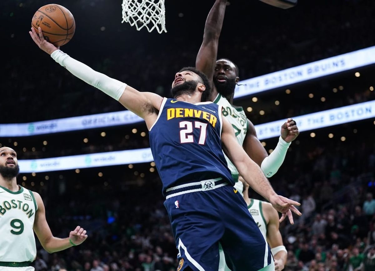 Jan 19, 2024; Boston, Massachusetts, USA; Denver Nuggets guard Jamal Murray (27) makes the basket against Boston Celtics guard Jaylen Brown (7) in the second quarter at TD Garden.