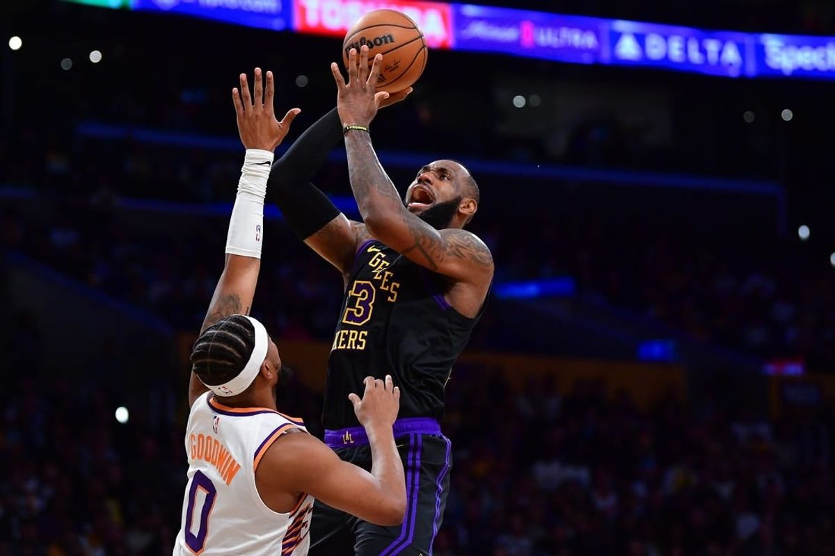 Dec 5, 2023; Los Angeles, California, USA; Los Angeles Lakers forward LeBron James (23) shoots against Phoenix Suns guard Jordan Goodwin (0) during the first half of the In Season Tournament quarterfinal at Crypto.com Arena.