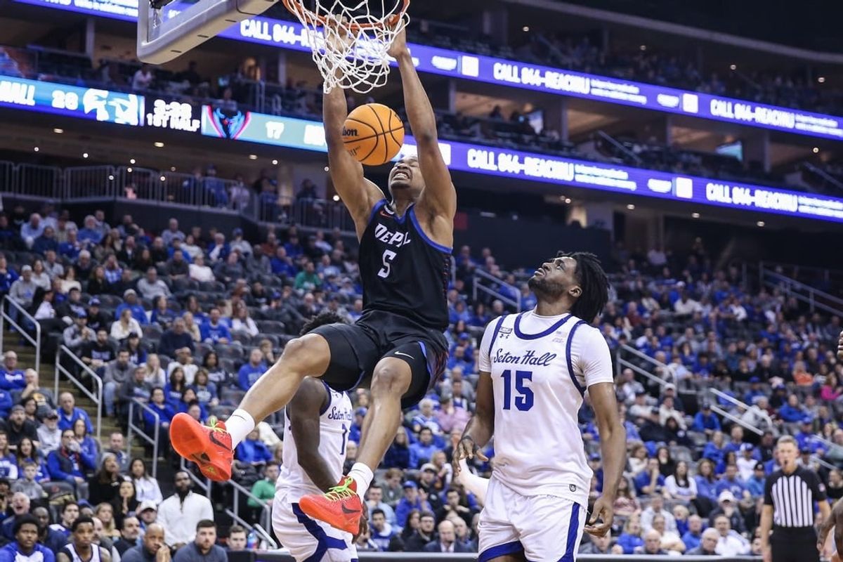 Mar 9, 2024; Newark, New Jersey, USA;  DePaul Blue Demons center Churchill Abass (5) dunks past Seton Hall Pirates center Jaden Bediako (15) in the first half at Prudential Center.