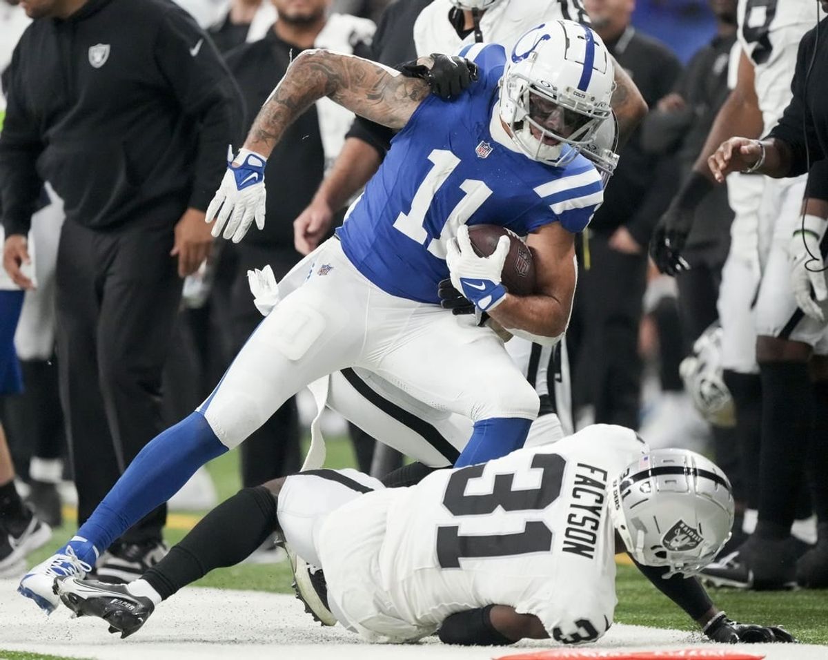 Dec 31, 2023; Indianapolis, Indiana, USA; Indianapolis Colts wide receiver Michael Pittman Jr. (11) runs out of bounds as Las Vegas Raiders cornerback Brandon Facyson (31) rolls at his feet during a game against the Las Vegas Raiders at Lucas Oil Stadium.