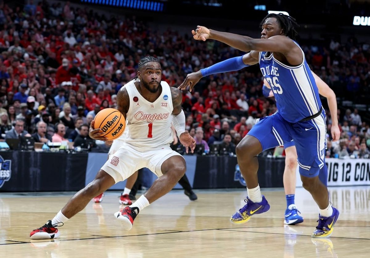 Mar 29, 2024; Dallas, TX, USA; Houston Cougars guard Jamal Shead (1) twists his right ankle driving against Duke Blue Devils forward Mark Mitchell (25) during the first half in the semifinals of the South Regional of the 2024 NCAA Tournament at American Airlines Center.