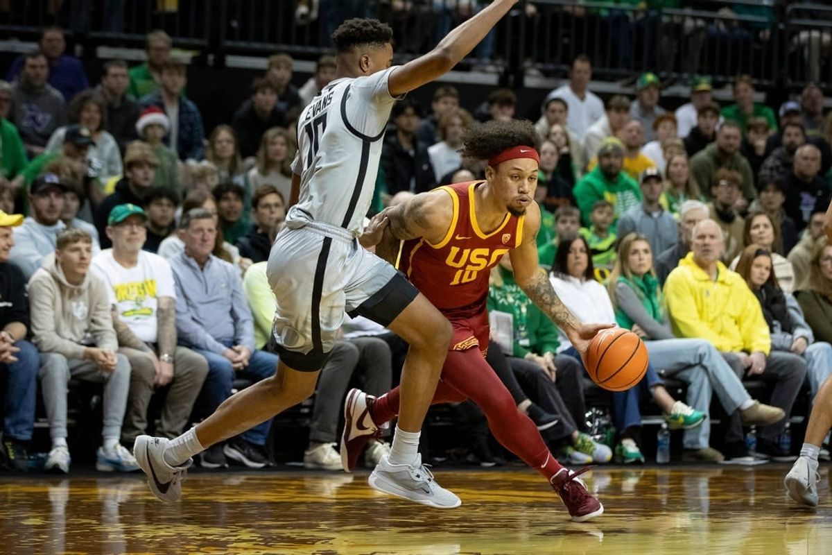 USC forward DJ Rodman drives toward the basket under cover from Oregon guard Kwame Evans Jr. as the Oregon Ducks host the USC Trojans Thursday, Dec. 28, 2023, at Matthew Knight Arena in Eugene, Ore.