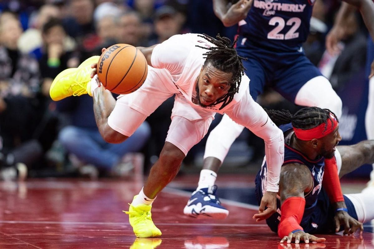 Nov 21, 2023; Philadelphia, Pennsylvania, USA; Cleveland Cavaliers guard Darius Garland (10) picks up a loose ball past Philadelphia 76ers forward Robert Covington (33) during the fourth quarter at Wells Fargo Center.