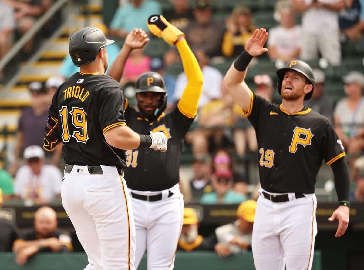 Mar 1, 2024; Bradenton, Florida, USA;  Pittsburgh Pirates third baseman Jared Triolo (19) is congratulated after he hit a 3-run home run during the second inning against the Tampa Bay Rays at LECOM Park.