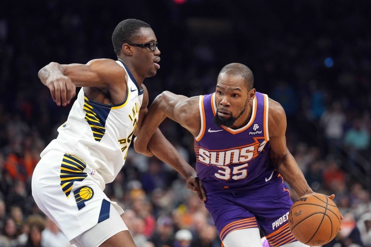 Jan 21, 2024; Phoenix, Arizona, USA; Phoenix Suns forward Kevin Durant (35) dribbles against Indiana Pacers forward Jalen Smith (25) during the first half at Footprint Center.