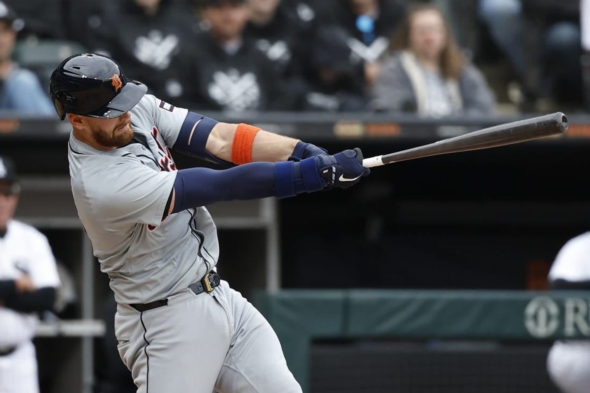 Mar 30, 2024; Chicago, Illinois, USA; Detroit Tigers catcher Carson Kelly (15) hits an RBI-single against the Chicago White Sox during the 10th inning at Guaranteed Rate Field.