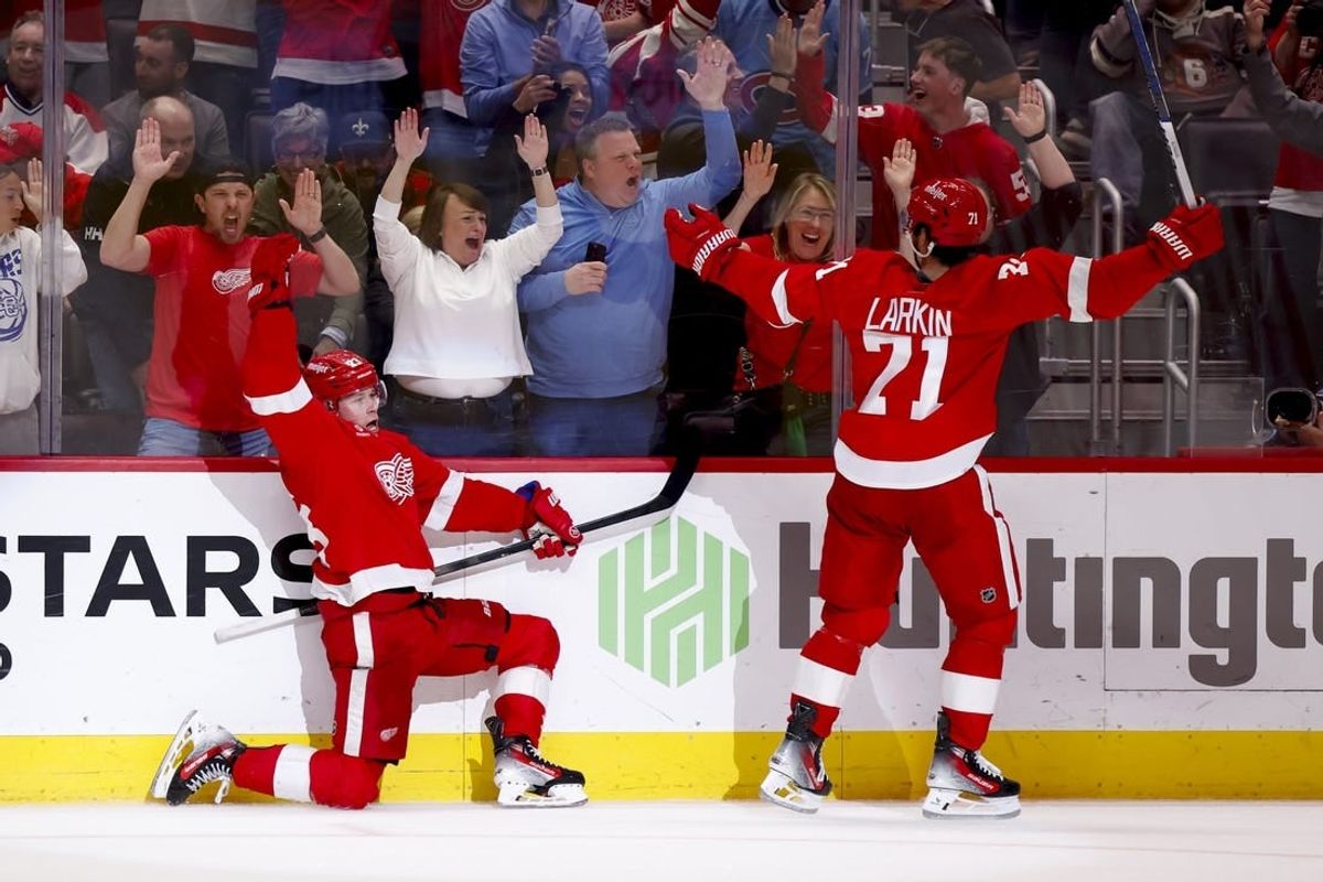 Apr 15, 2024; Detroit, Michigan, USA;  Detroit Red Wings left wing Lucas Raymond (23) celebrates with center Dylan Larkin (71) after he scores in overtime against the Montreal Canadiens at Little Caesars Arena.