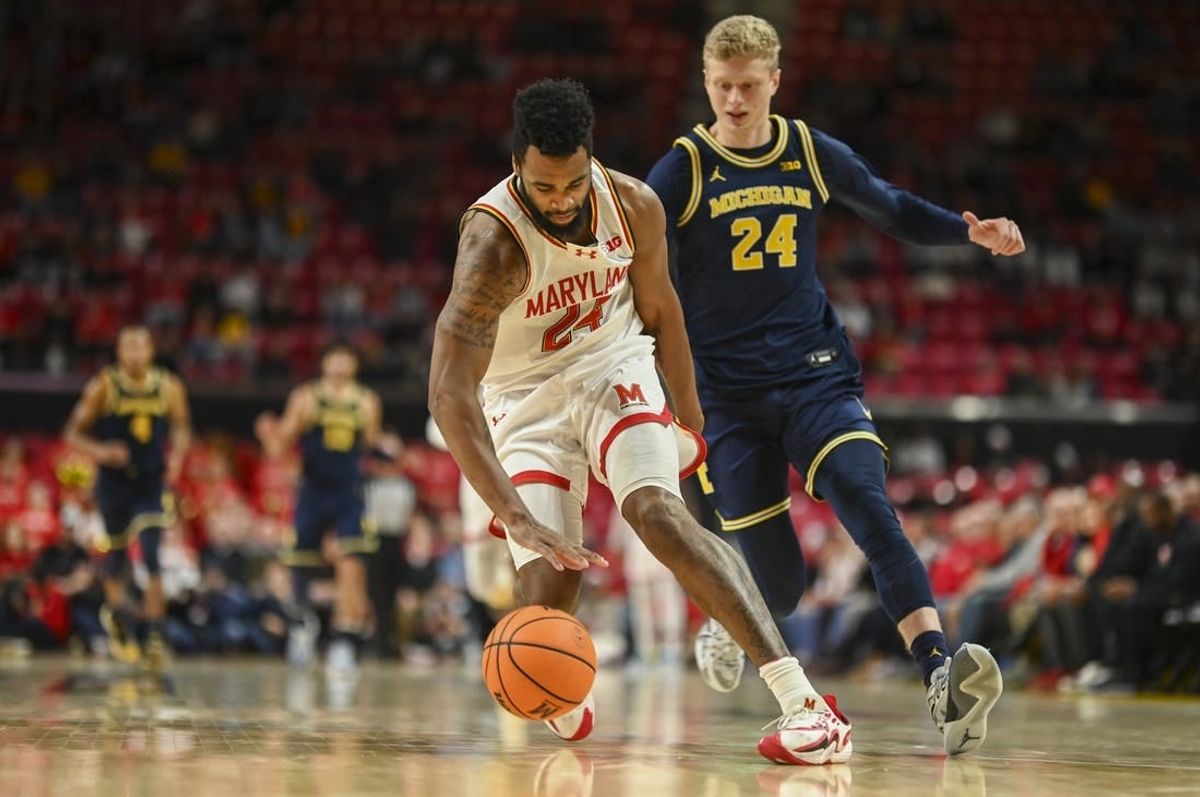 Jan 11, 2024; College Park, Maryland, USA;  Maryland Terrapins forward Donta Scott (24) runs down a loose ball in the backcourt as Michigan Wolverines forward Youssef Khayat (24) chases during the first half at Xfinity Center.