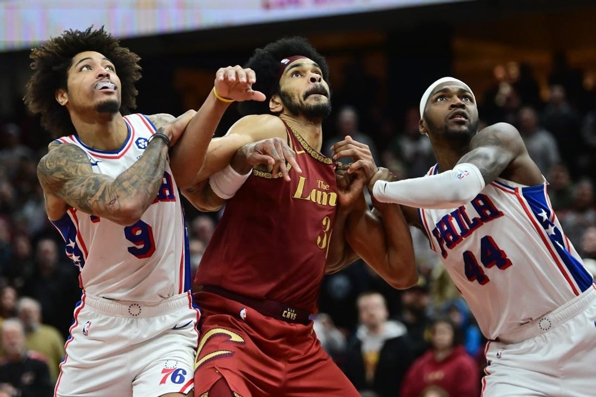 Feb 12, 2024; Cleveland, Ohio, USA; Cleveland Cavaliers center Jarrett Allen (31) fights for position against Philadelphia 76ers guard Kelly Oubre Jr. (9) and forward Paul Reed (44) during the second half at Rocket Mortgage FieldHouse.