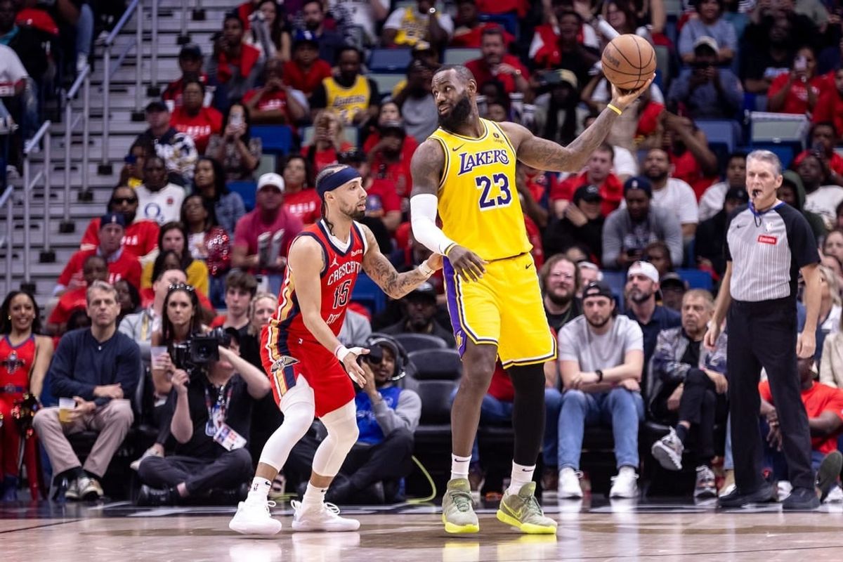 Apr 16, 2024; New Orleans, Louisiana, USA; Los Angeles Lakers forward LeBron James (23) looks to pass the ball against New Orleans Pelicans guard Jose Alvarado (15) during the first half of a play-in game of the 2024 NBA playoffs against the New Orleans Pelicans at Smoothie King Center.