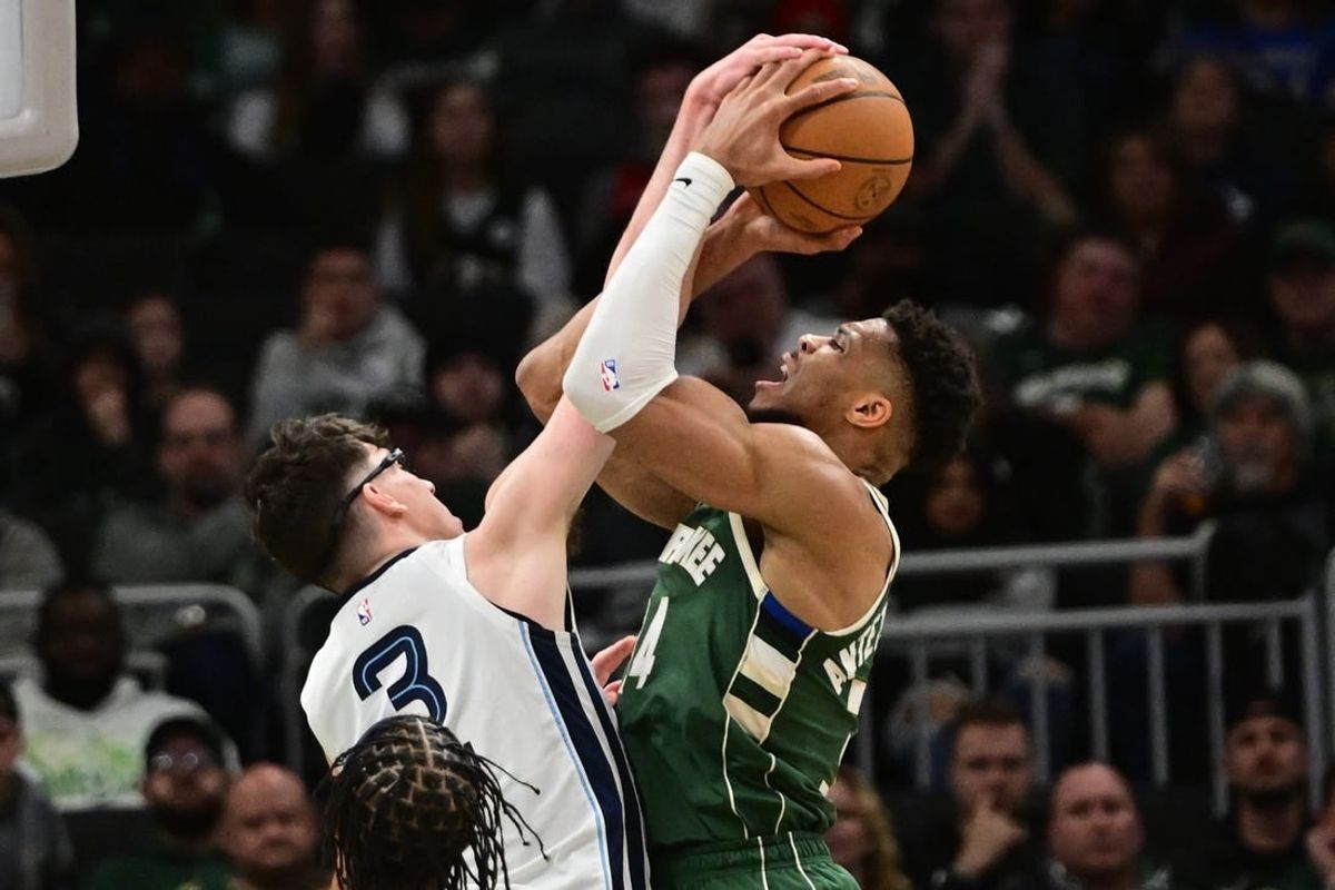 Apr 3, 2024; Milwaukee, Wisconsin, USA; Milwaukee Bucks forward Giannis Antetokounmpo (34) takes a shot against Memphis Grizzlies forward Jake LaRavia (3) in the first quarter at Fiserv Forum.