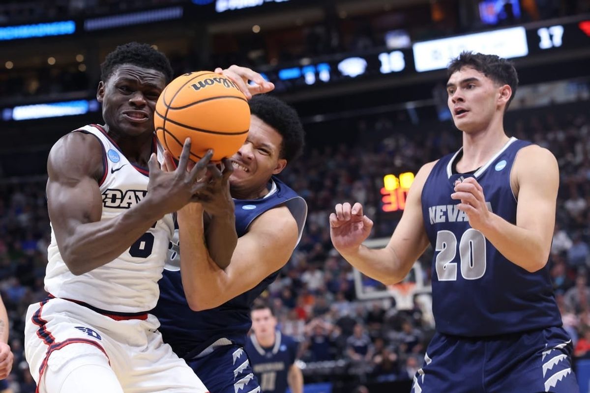 Mar 21, 2024; Salt Lake City, UT, USA; Dayton Flyers guard Enoch Cheeks (6) battles for the ball against  Nevada Wolf Pack forward Tylan Pope (33)during the first half in the first round of the 2024 NCAA Tournament at Vivint Smart Home Arena-Delta Center.