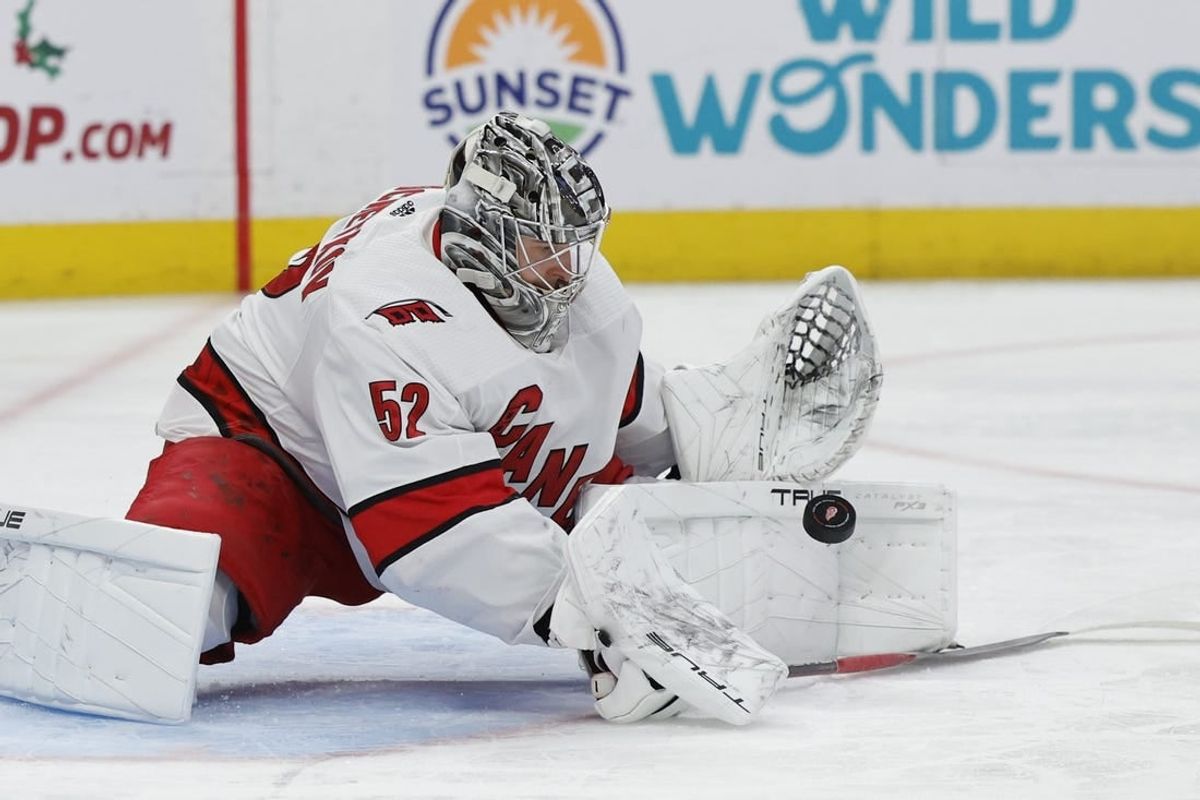 Dec 14, 2023; Detroit, Michigan, USA; Carolina Hurricanes goaltender Pyotr Kochetkov (52) makes a save in the second period against the Detroit Red Wings at Little Caesars Arena.