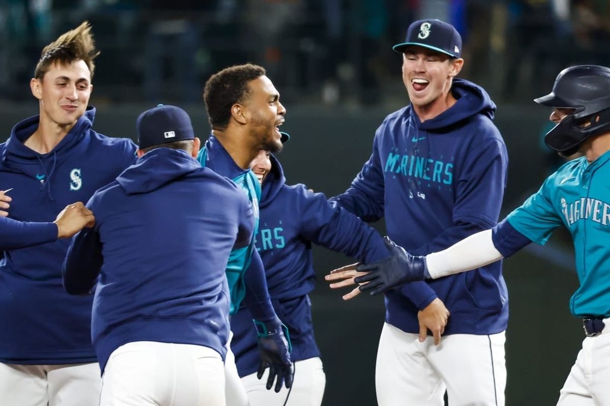 Mar 30, 2024; Seattle, Washington, USA; Seattle Mariners center fielder Julio Rodriguez (44, middle) celebrates after hitting a walk-off RBI-single against the Boston Red Sox during the tenth inning at T-Mobile Park.