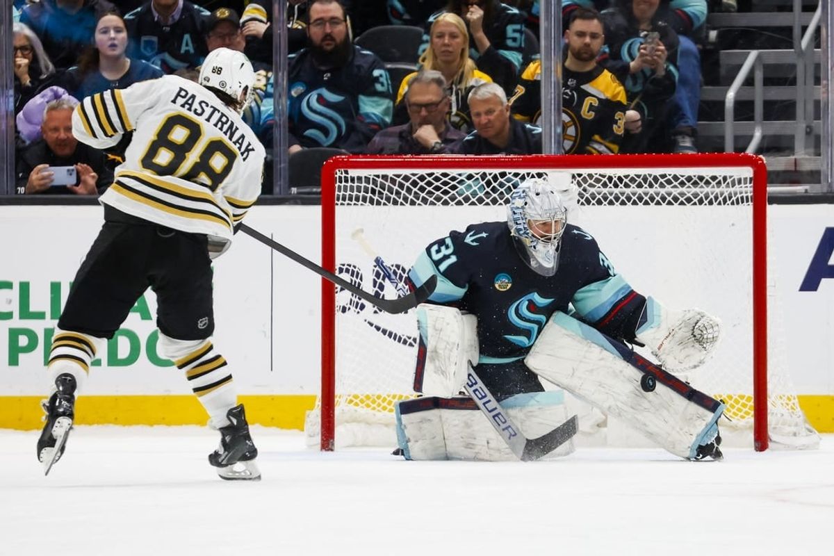 Feb 26, 2024; Seattle, Washington, USA; Seattle Kraken goaltender Philipp Grubauer (31) makes a save against Boston Bruins right wing David Pastrnak (88) during an overtime shootout at Climate Pledge Arena.