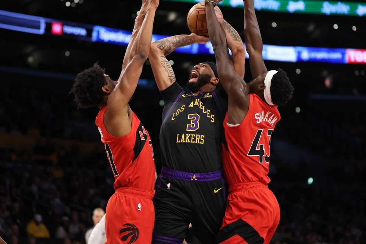 Jan 9, 2024; Los Angeles, California, USA; Los Angeles Lakers forward Anthony Davis (3) shoots the ball between Toronto Raptors forward Thaddeus Young (21) and forward Pascal Siakam (43) during the first quarter at Crypto.com Arena.