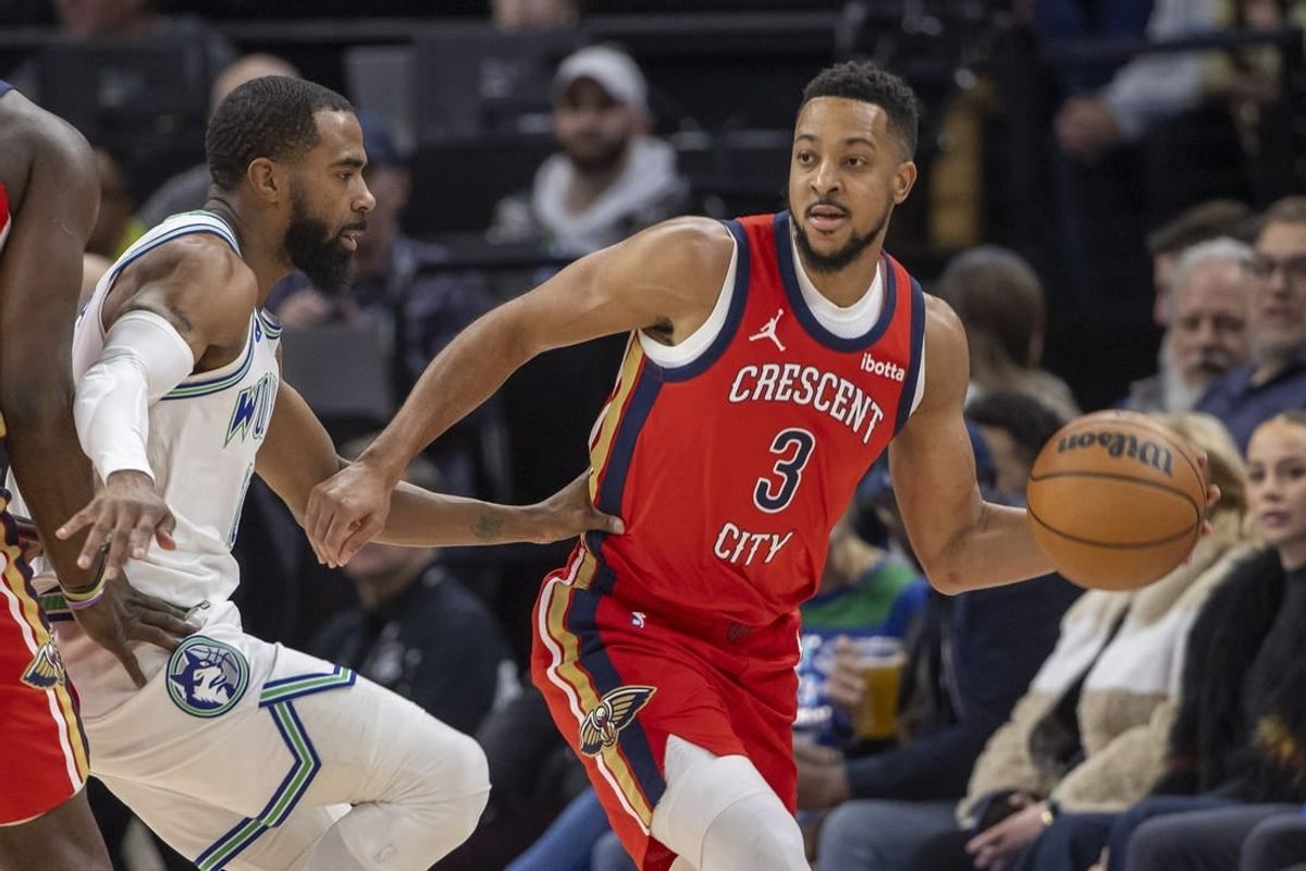 Jan 3, 2024; Minneapolis, Minnesota, USA; New Orleans Pelicans guard CJ McCollum (3) looks to pass the ball around Minnesota Timberwolves guard Mike Conley (10) in the first half at Target Center.
