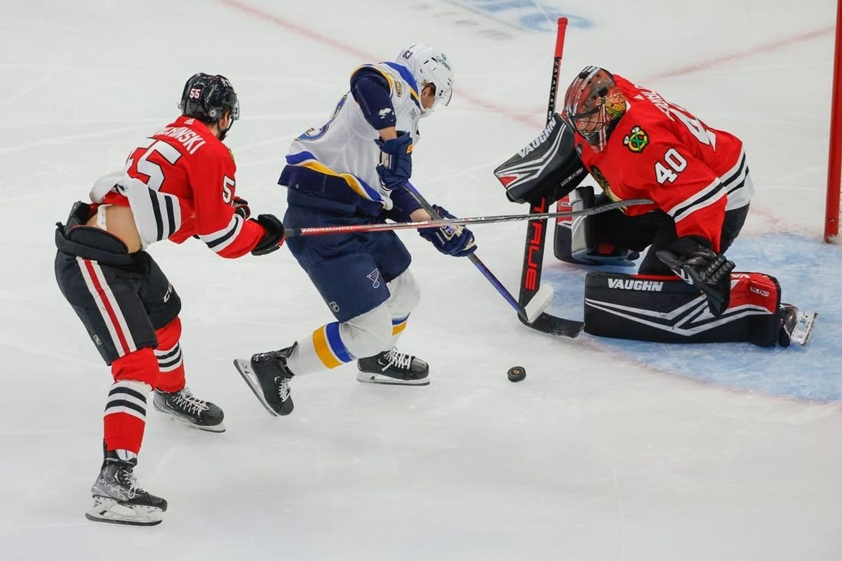 Nov 26, 2023; Chicago, Illinois, USA; St. Louis Blues left wing Jake Neighbours (63) attempts to score against  Chicago Blackhawks goaltender Arvid Soderblom (40) during the first period at United Center.