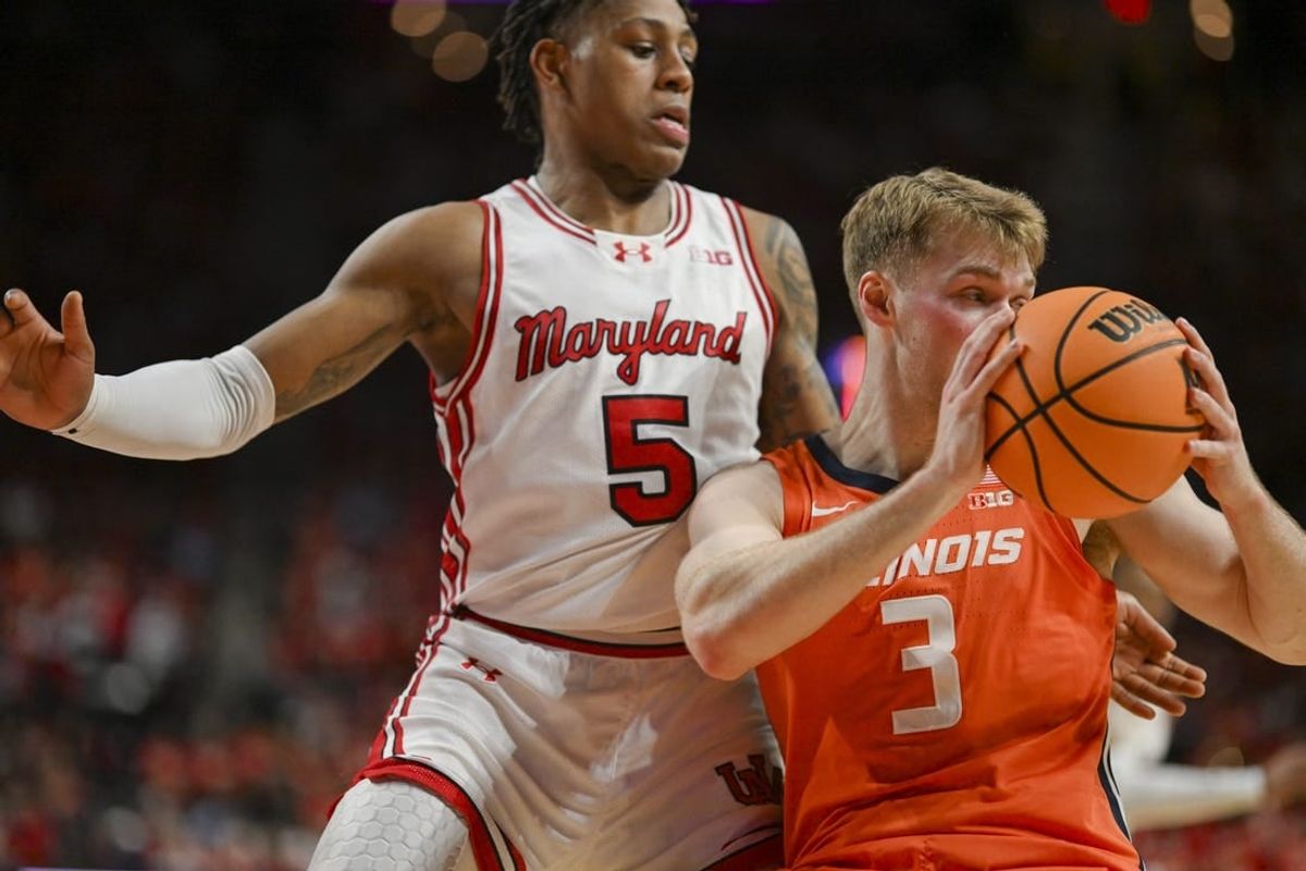 Feb 17, 2024; College Park, Maryland, USA;  Illinois Fighting Illini forward Marcus Domask (3) looks to pass as Maryland Terrapins guard DeShawn Harris-Smith (5) defends during the first  half at Xfinity Center.