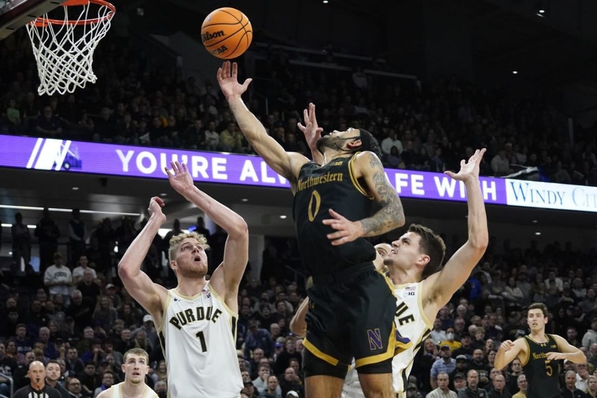 Dec 1, 2023; Evanston, Illinois, USA; Purdue Boilermakers forward Caleb Furst (1) defends Northwestern Wildcats guard Boo Buie (0) during the second half at Welsh-Ryan Arena.