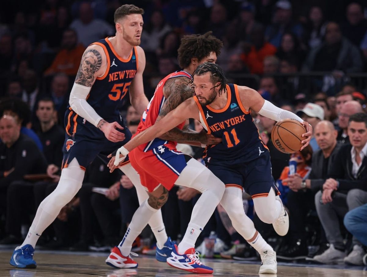 Apr 22, 2024; New York, New York, USA;  New York Knicks guard Jalen Brunson (11) dribbles as Philadelphia 76ers guard Kelly Oubre Jr. (9) defends in front of center Isaiah Hartenstein (55) during the first half during game two of the first round for the 2024 NBA playoffs at Madison Square Garden.