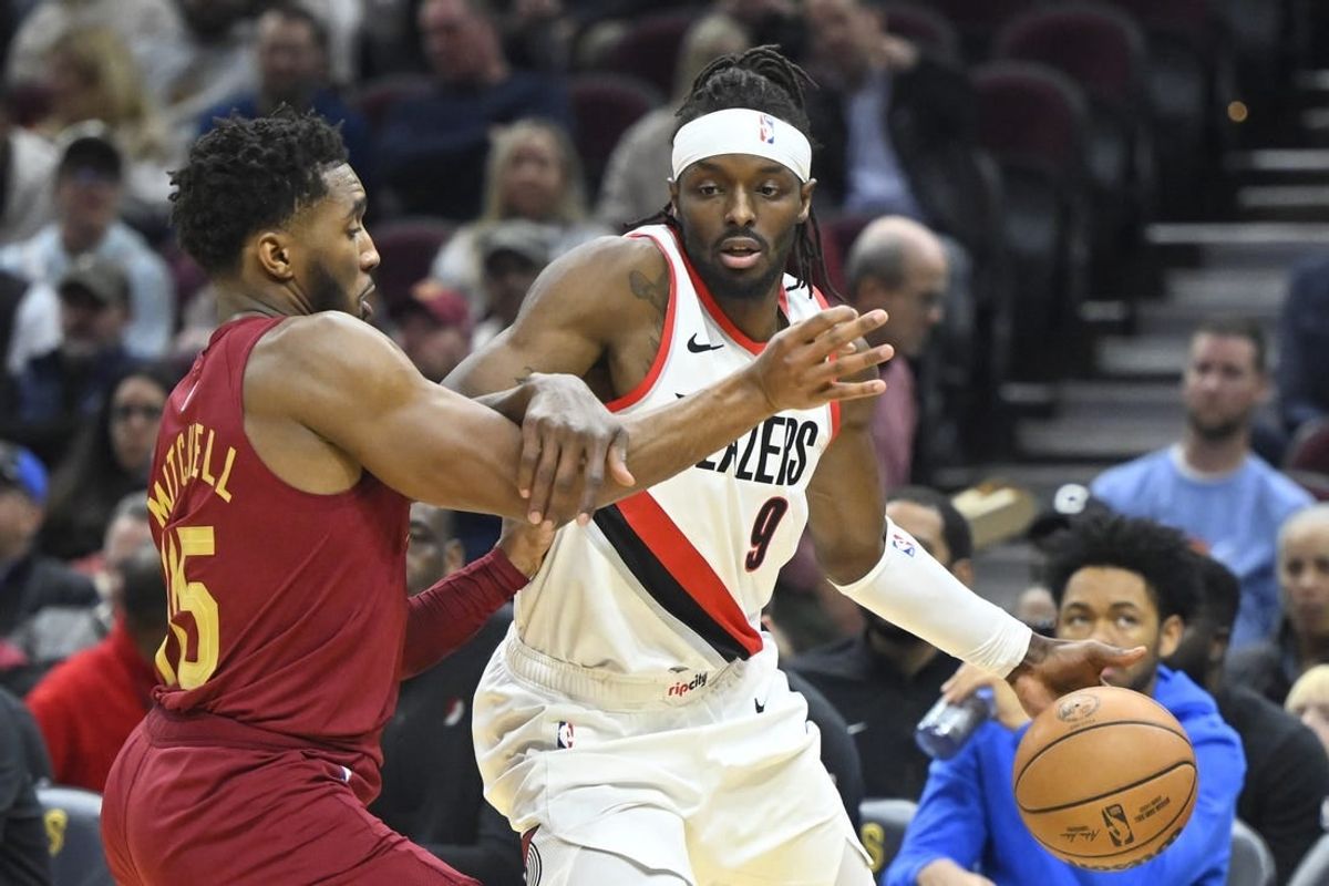 Nov 30, 2023; Cleveland, Ohio, USA; Portland Trail Blazers forward Jerami Grant (9) drives against Cleveland Cavaliers guard Donovan Mitchell (45) in the second quarter at Rocket Mortgage FieldHouse.