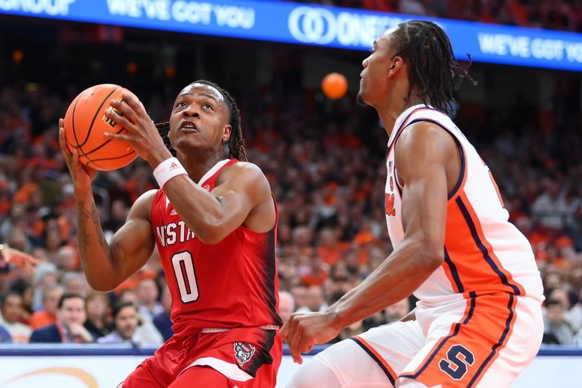 Jan 27, 2024; Syracuse, New York, USA; North Carolina State Wolfpack guard DJ Horne (0) drives as Syracuse Orange guard JJ Starling (2) defends during the first half at the JMA Wireless Dome.
