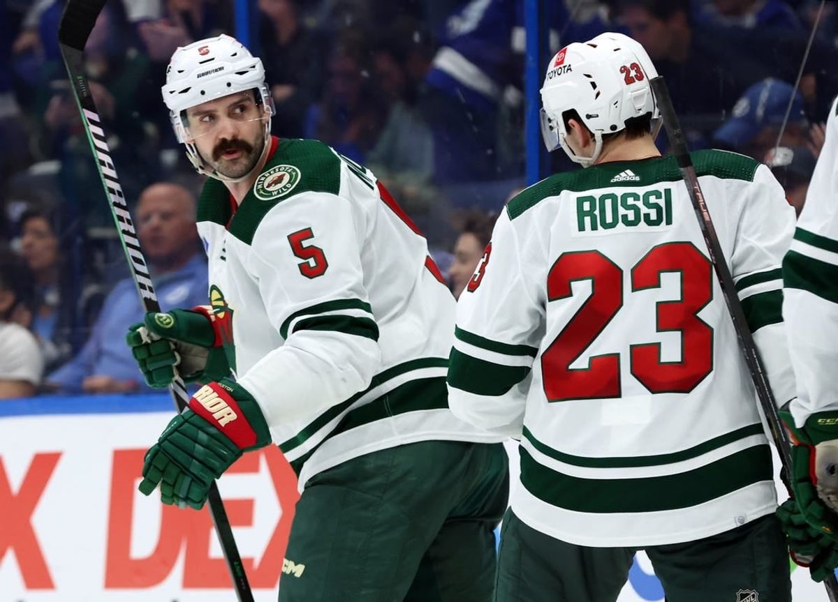 Jan 18, 2024; Tampa, Florida, USA; Minnesota Wild defenseman Jake Middleton (5) is congratulated after scoring against the Tampa Bay Lightning during the second period at Amalie Arena.