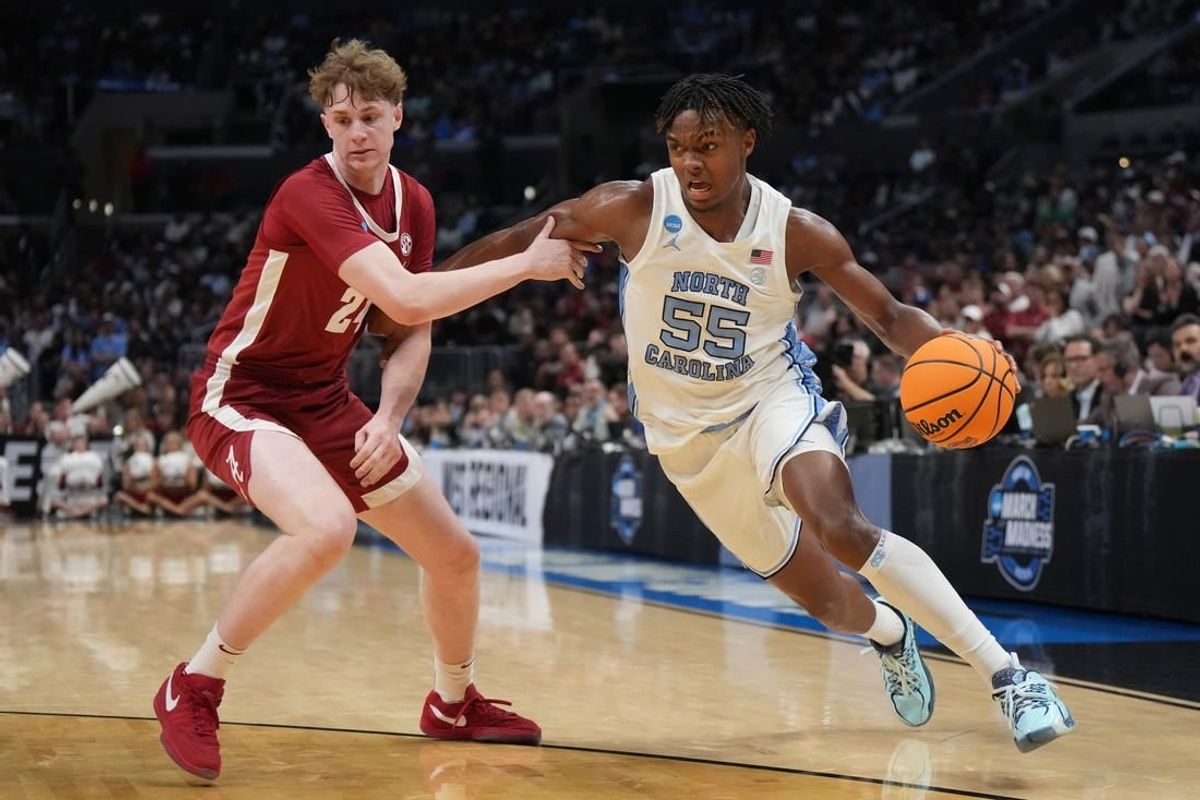 Mar 28, 2024; Los Angeles, CA, USA; North Carolina Tar Heels forward Harrison Ingram (55) controls the ball against Alabama Crimson Tide forward Sam Walters (24) in the second half in the semifinals of the West Regional of the 2024 NCAA Tournament at Crypto.com Arena.