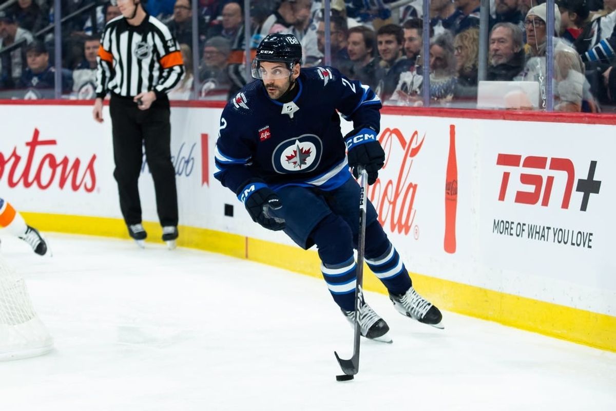 Jan 16, 2024; Winnipeg, Manitoba, CAN; Winnipeg Jets defenseman Dylan DeMelo (2) looks to make a pass against the New York Islanders during the first period at Canada Life Centre.