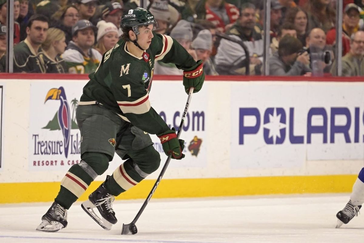 Jan 4, 2024; Saint Paul, Minnesota, USA; Minnesota Wild defenseman Brock Faber (7) makes a pass against the Tampa Bay Lightning during the third period at Xcel Energy Center.