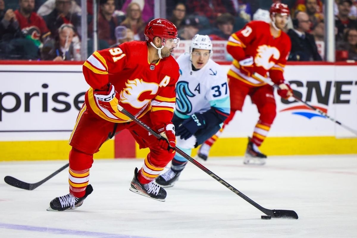 Mar 4, 2024; Calgary, Alberta, CAN; Calgary Flames center Nazem Kadri (91) controls the puck against the Seattle Kraken during the third period at Scotiabank Saddledome.
