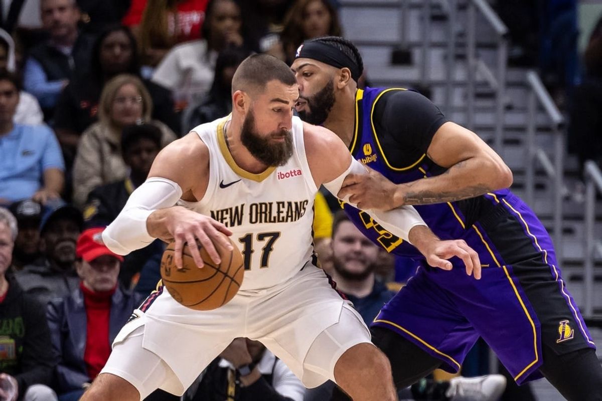 Dec 31, 2023; New Orleans, Louisiana, USA;  New Orleans Pelicans center Jonas Valanciunas (17) dribbles against Los Angeles Lakers forward Anthony Davis (3) during the first half at Smoothie King Center.