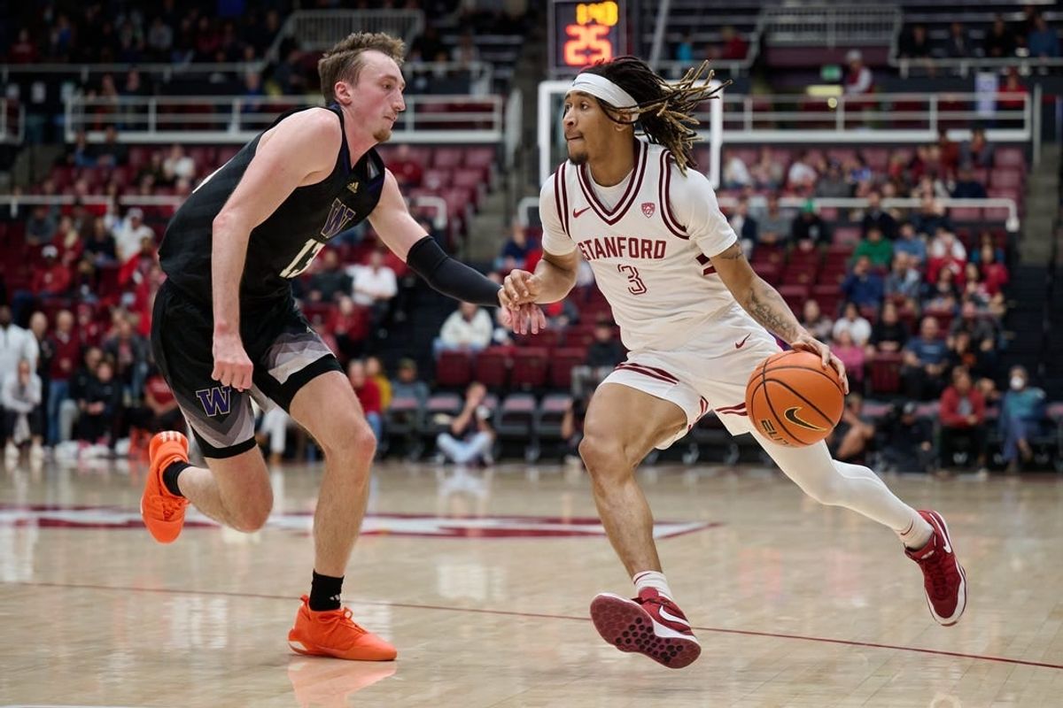 Jan 20, 2024; Stanford, California, USA; Stanford Cardinal guard Kanaan Carlyle (3) dribbles the ball against Washington Huskies forward Moses Wood (13) during the first half at Maples Pavilion.