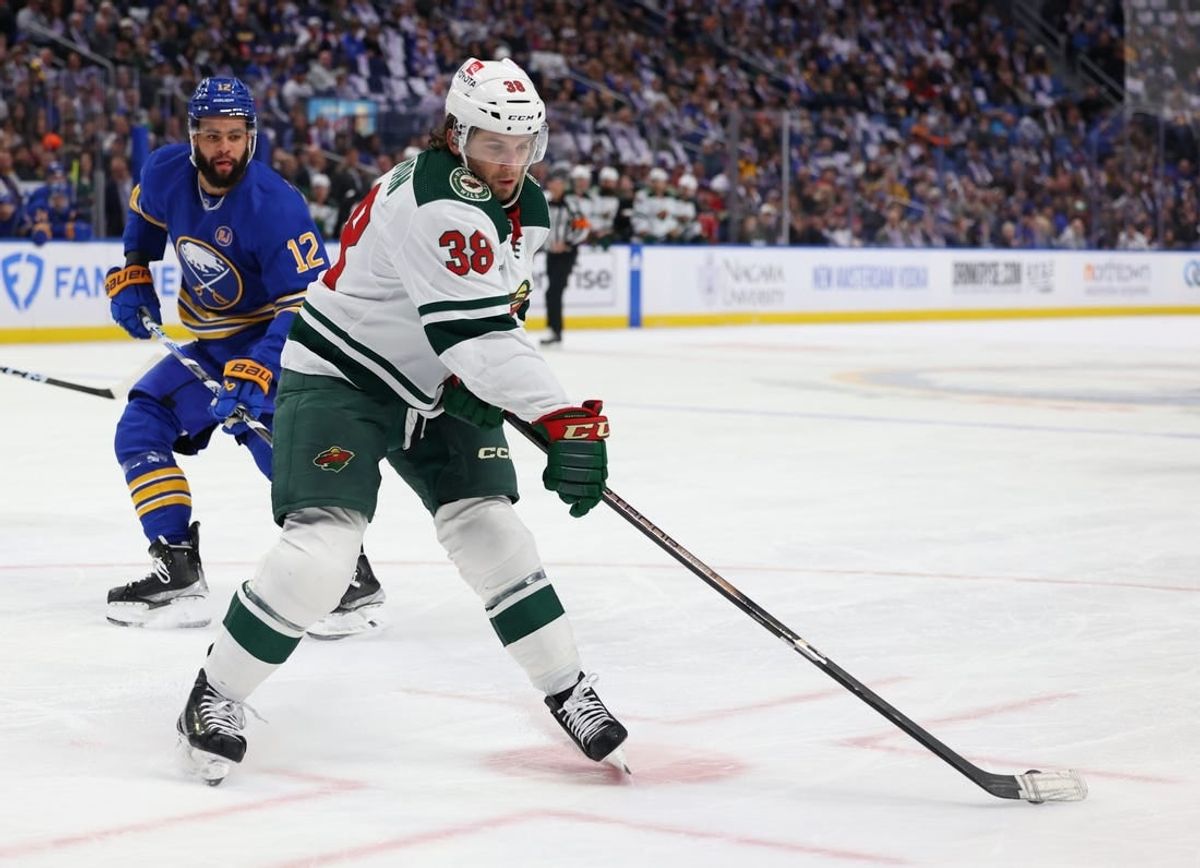 Nov 10, 2023; Buffalo, New York, USA;  Buffalo Sabres left wing Jordan Greenway (12) watches as Minnesota Wild right wing Ryan Hartman (38) drops a pass during the first period at KeyBank Center.