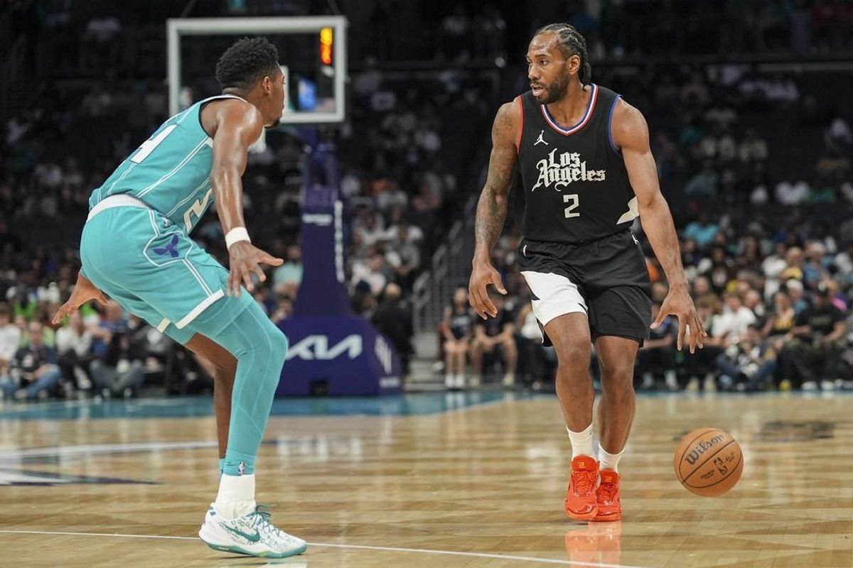 Mar 31, 2024; Charlotte, North Carolina, USA; LA Clippers forward Kawhi Leonard (2) on the dribble against Charlotte Hornets forward Brandon Miller (24) during the second half at Spectrum Center.