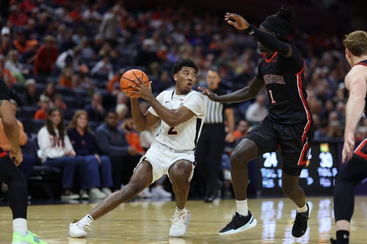 Dec 16, 2023; Charlottesville, Virginia, USA; Virginia Cavaliers guard Reece Beekman (2) holds the ball as Northeastern Huskies guard Masai Troutman (1) defends in the second half at John Paul Jones Arena.
