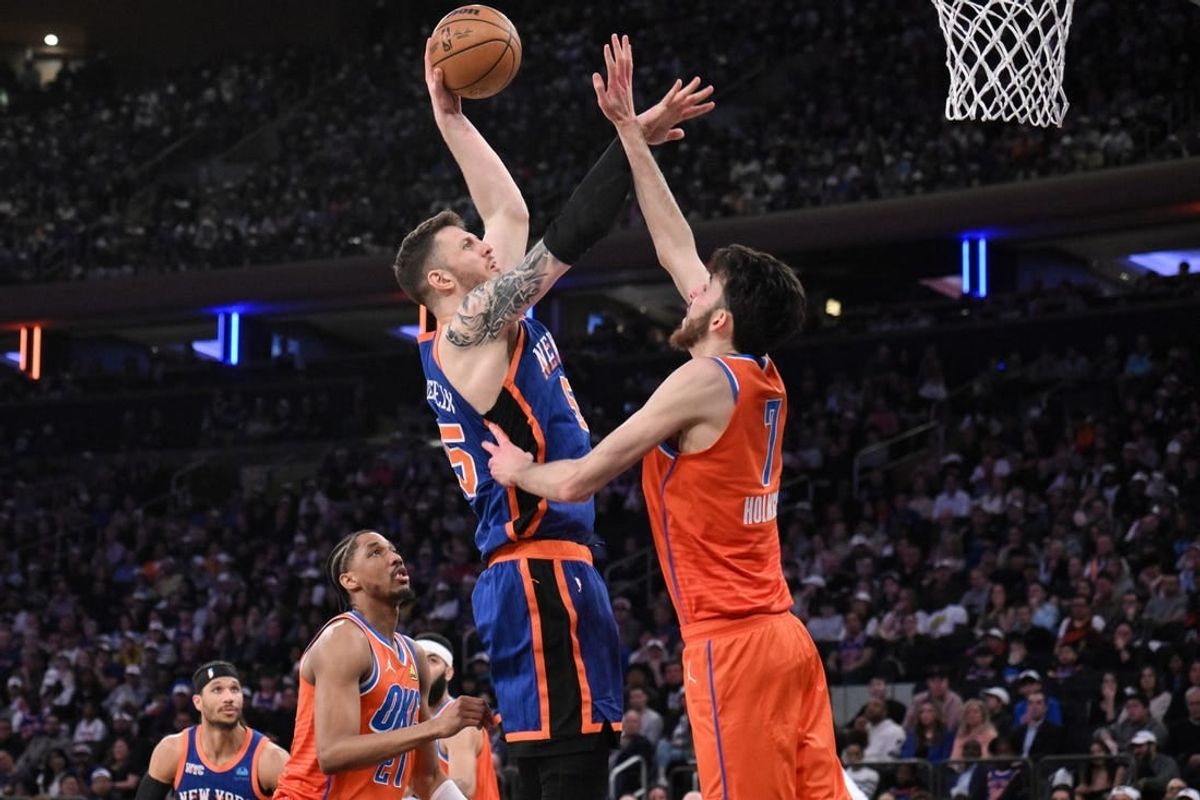 Mar 31, 2024; New York, New York, USA; New York Knicks center Isaiah Hartenstein (55) shoots the ball while being defended by Oklahoma City Thunder forward Chet Holmgren (7) and Oklahoma City Thunder guard Aaron Wiggins (21) during the second quarter at Madison Square Garden.