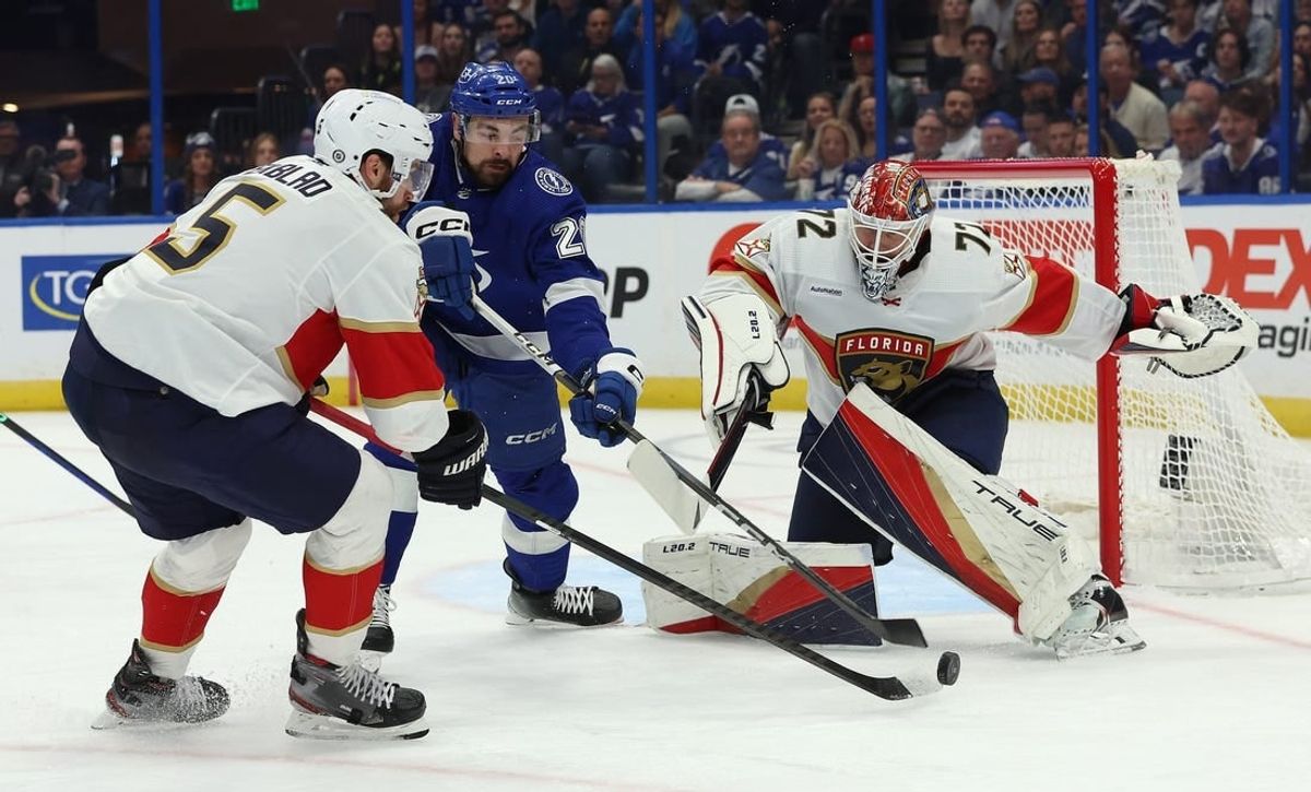 Dec 27, 2023; Tampa, Florida, USA; Florida Panthers defenseman Aaron Ekblad (5), Tampa Bay Lightning left wing Nicholas Paul (20) and Florida Panthers goaltender Sergei Bobrovsky (72) go after the puck during the first period at Amalie Arena.