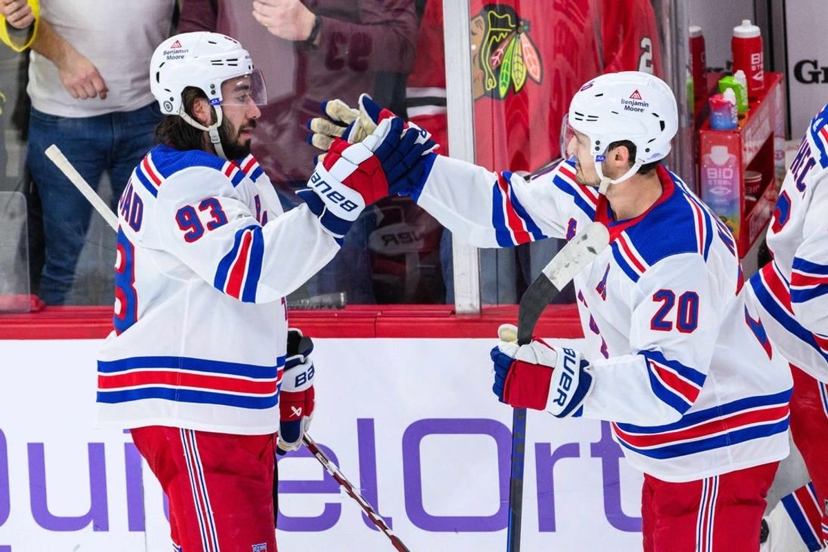 Feb 9, 2024; Chicago, Illinois, USA; New York Rangers center Mika Zibanejad (93) celebrates with center Rem Pitlick (20) against the Chicago Blackhawks after the game at the United Center.