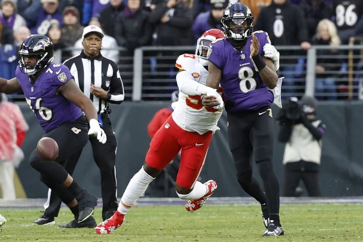 Jan 28, 2024; Baltimore, Maryland, USA; Kansas City Chiefs defensive end Charles Omenihu (90) strips the ball from Baltimore Ravens quarterback Lamar Jackson (8) in the AFC Championship football game at M&T Bank Stadium.