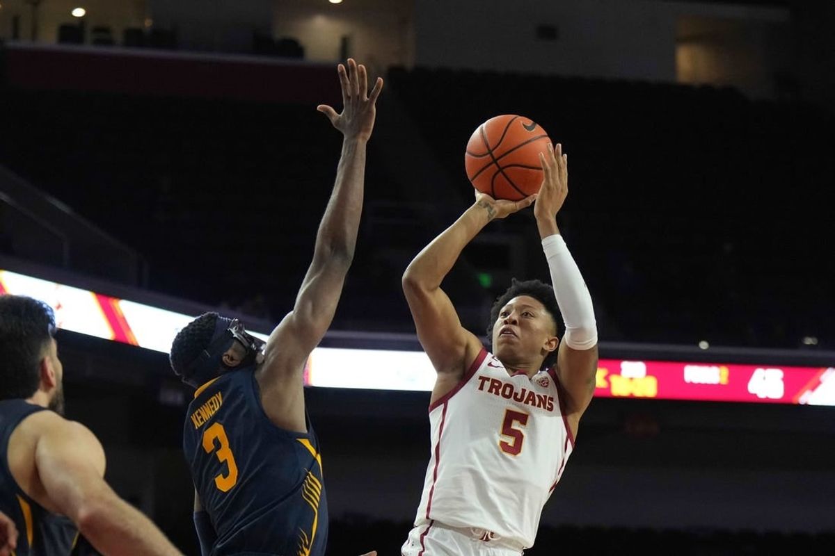 Jan 3, 2024; Los Angeles, California, USA; Southern California Trojans guard Boogie Ellis (5) shoots the ball against California Golden Bears guard Keonte Kennedy (3) in the second half at Galen Center.