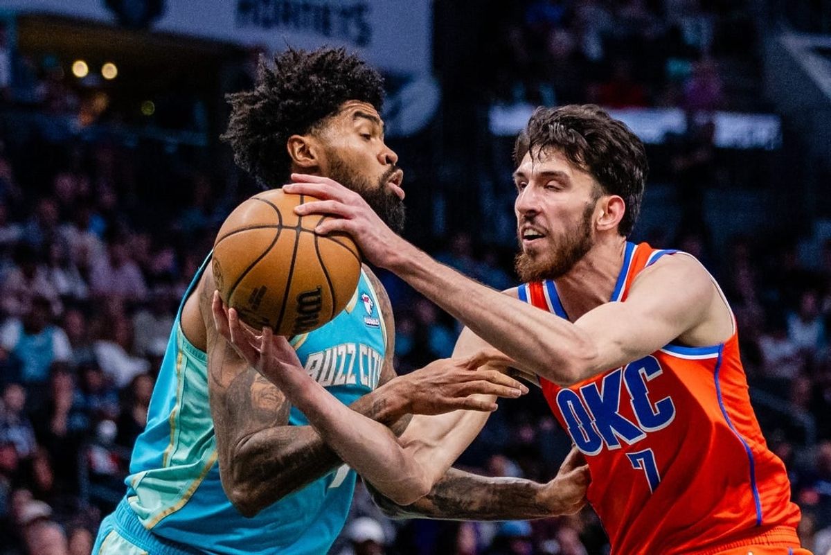 Apr 7, 2024; Charlotte, North Carolina, USA; Charlotte Hornets center Nick Richards (4) fouls Oklahoma City Thunder forward Chet Holmgren (7) during the second quarter at Spectrum Center.