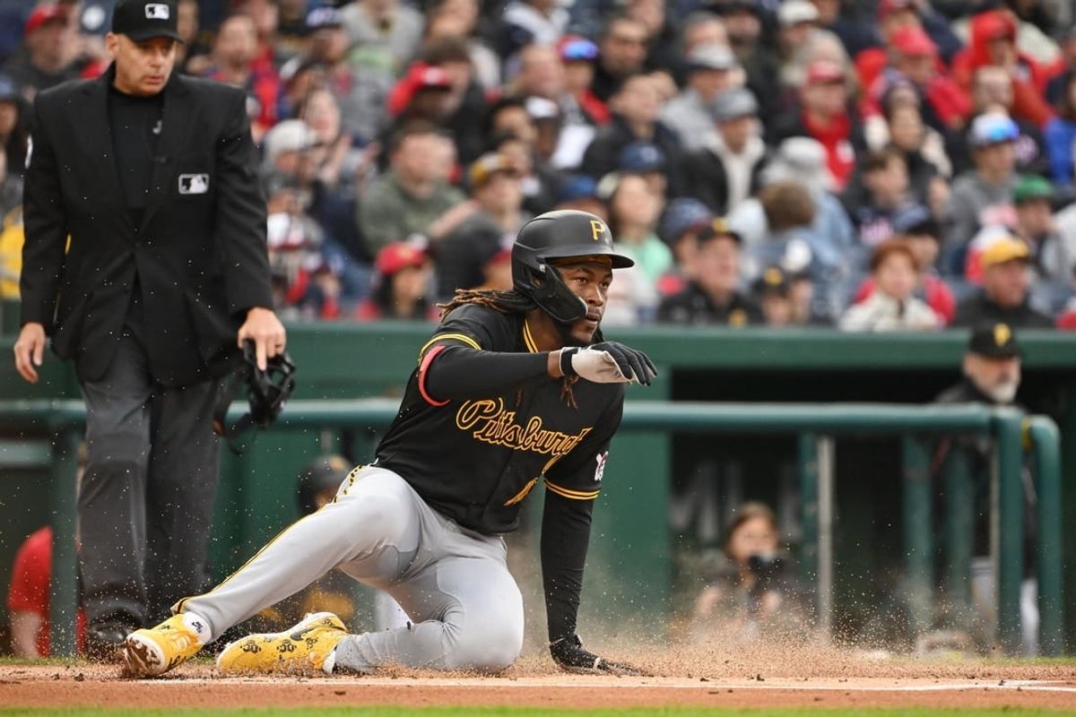 Apr 1, 2024; Washington, District of Columbia, USA; Pittsburgh Pirates shortstop Oneil Cruz (15) slides into home to score a run against the Washington Nationals at Nationals Park.