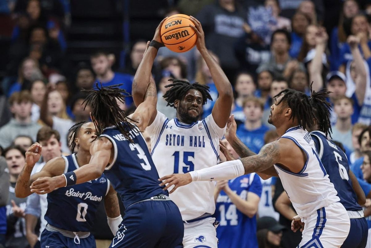 Nov 6, 2023; Newark, New Jersey, USA; Seton Hall Pirates center Jaden Bediako (15) rebounds against St. Peter's Peacocks forward Corey Washington (3) during the first half at Prudential Center.