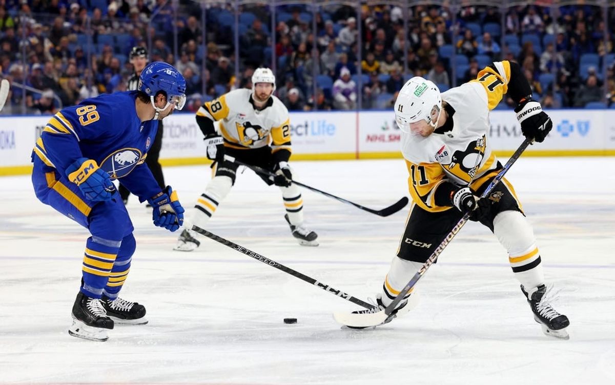 Nov 24, 2023; Buffalo, New York, USA;  Buffalo Sabres right wing Alex Tuch (89) and Pittsburgh Penguins left wing Alex Nylander (11) go after a loose puck during the first period at KeyBank Center.